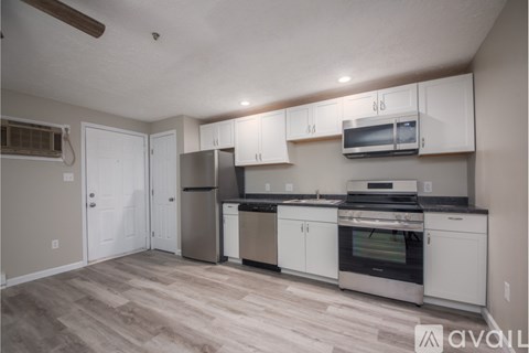 A kitchen with white cabinets and stainless steel appliances.