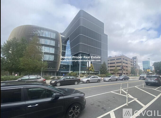 A modern building with a curved glass facade is part of the Boston Property Real Estate group.