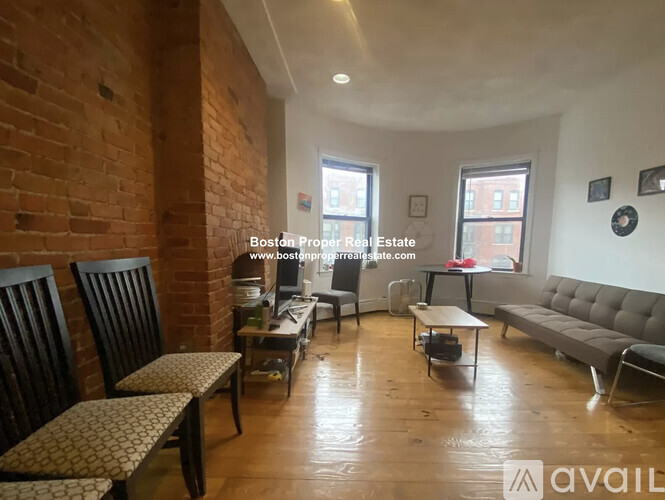 A living room with a couch, chairs, and a coffee table.