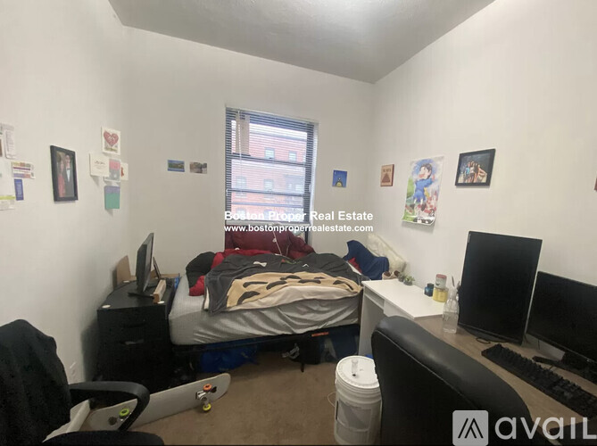 A bedroom with a bed, desk, and chair.