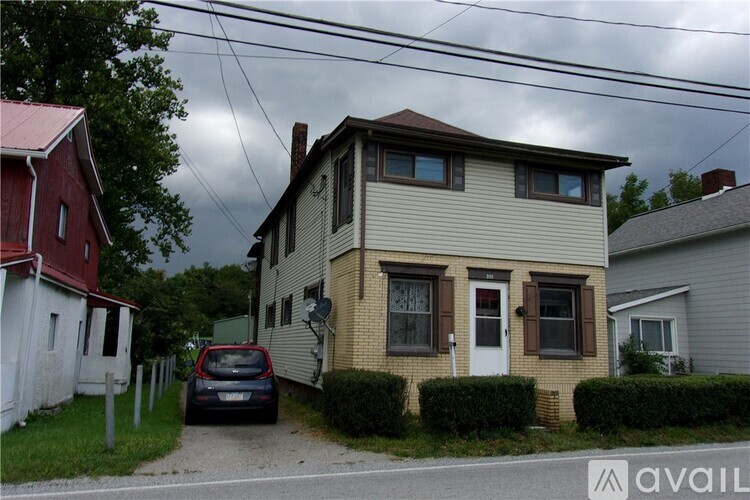 A house with a car parked in front of it.