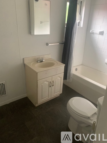 A bathroom with a sink, toilet and bathtub.