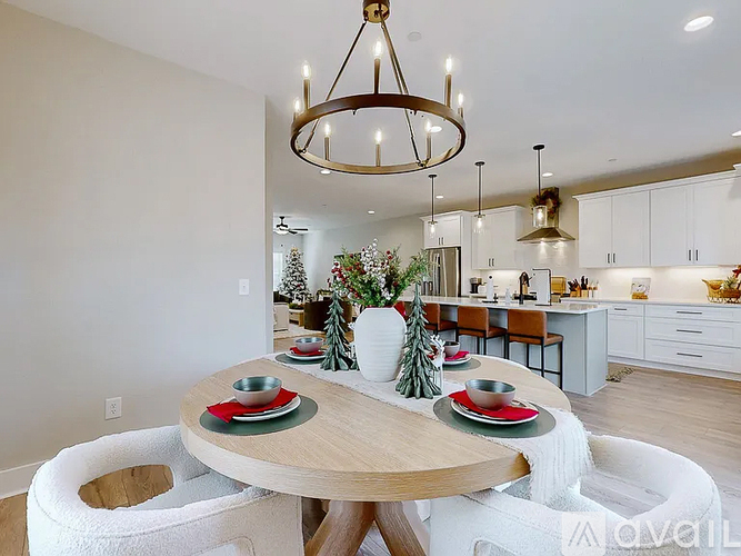 A dining room with a round table set for a meal.