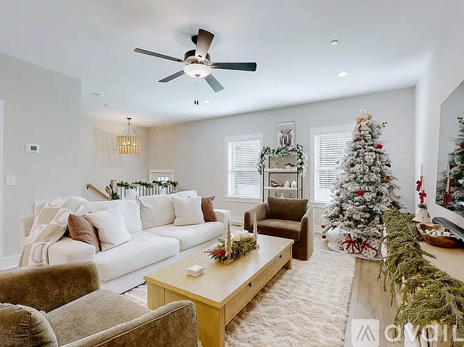 A living room with a Christmas tree and decorations.