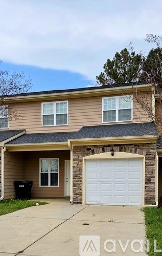 A house with a brown siding and a white garage door.