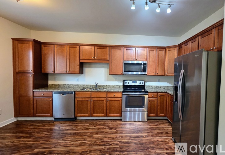 A kitchen with wooden cabinets and stainless steel appliances.