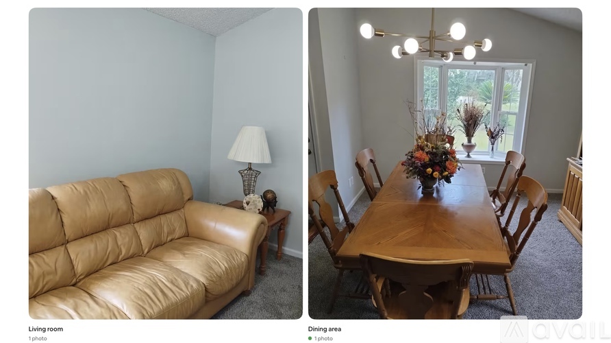A living room with a tan couch and a dining area with a wooden table and chairs.