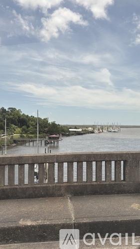 A bridge over a river with a cloudy sky in the background.