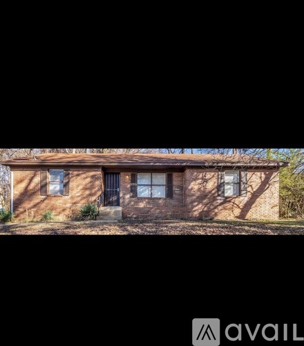A house with a black door and windows is available for sale.