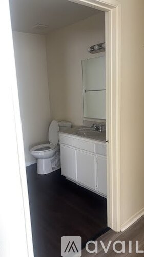 A white toilet and sink in a small bathroom.