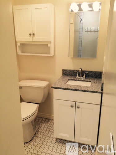 A white toilet and sink in a bathroom.