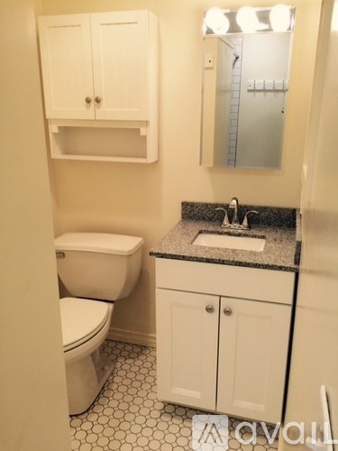 A white toilet and sink in a bathroom.