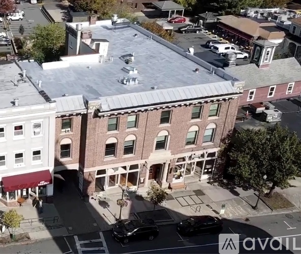 A street view of a town with a building in the center.