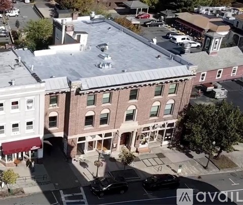 A street view of a town with a building in the center.