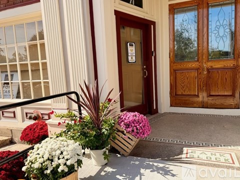 A brown door with a glass window and a sign on it.