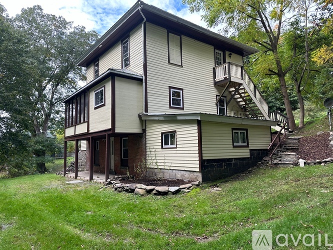 A two-story house with a balcony on the upper floor.