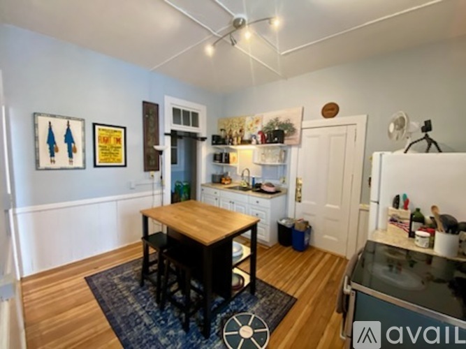 A kitchen with a table and chairs in the middle of the room.