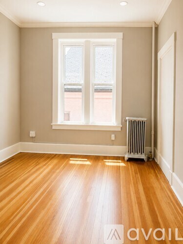 A bedroom with a bed in the center and a desk with a chair in the corner.