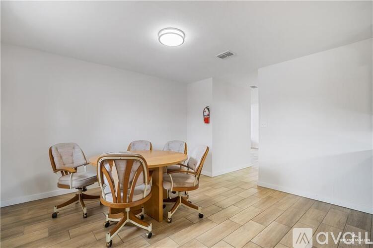 A conference room with a table and chairs.