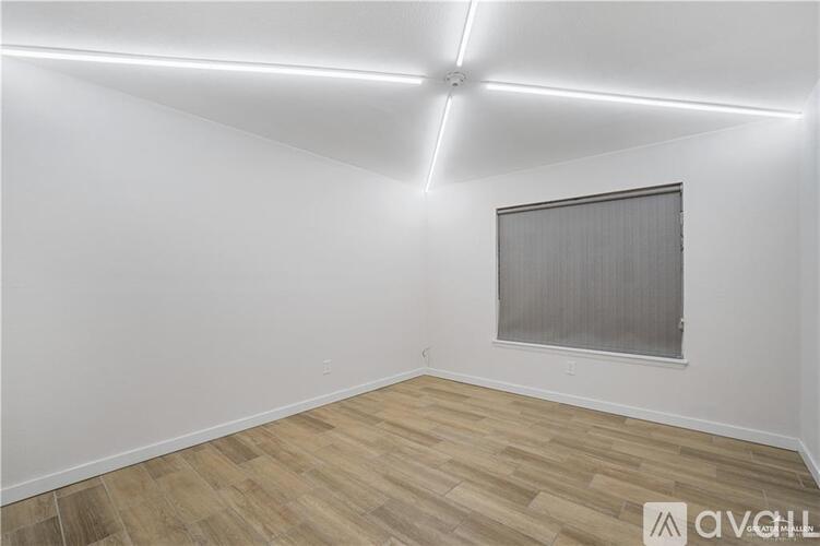 A room with wooden flooring and a ceiling fan.