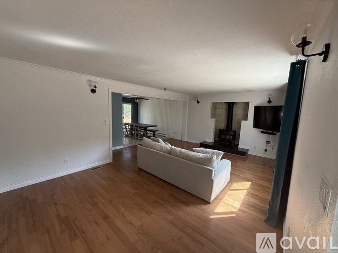A living room with a white couch and a television.