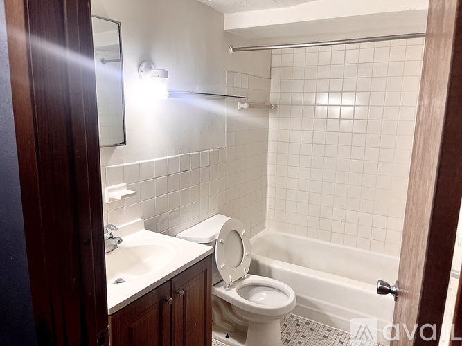 A bathroom with a toilet, sink, and bathtub.