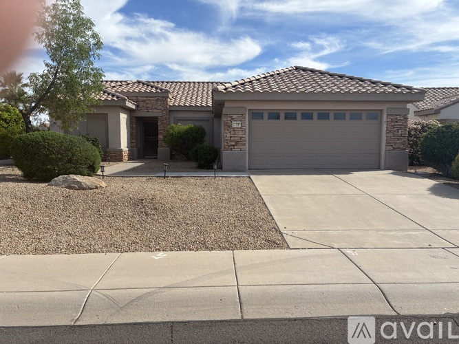 A house with a garage and a driveway in front.