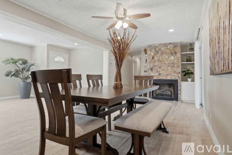 A dining room with a wooden table and chairs.