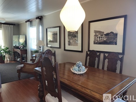 A dining room with a wooden table and chairs.