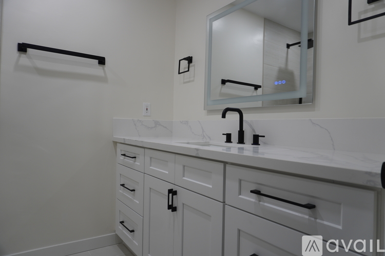 A bathroom with a sink and a mirror.