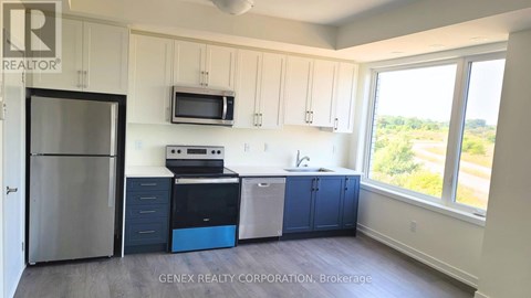 A kitchen with white cabinets and a blue dishwasher.