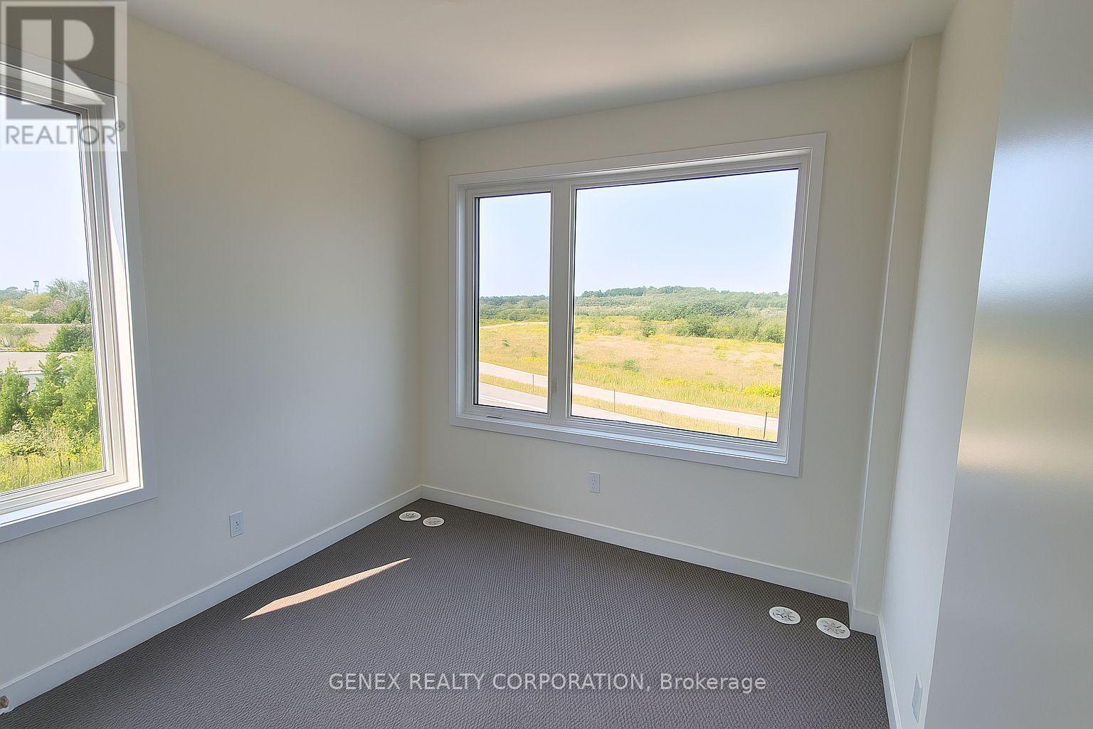 A room with a large window overlooking a field.