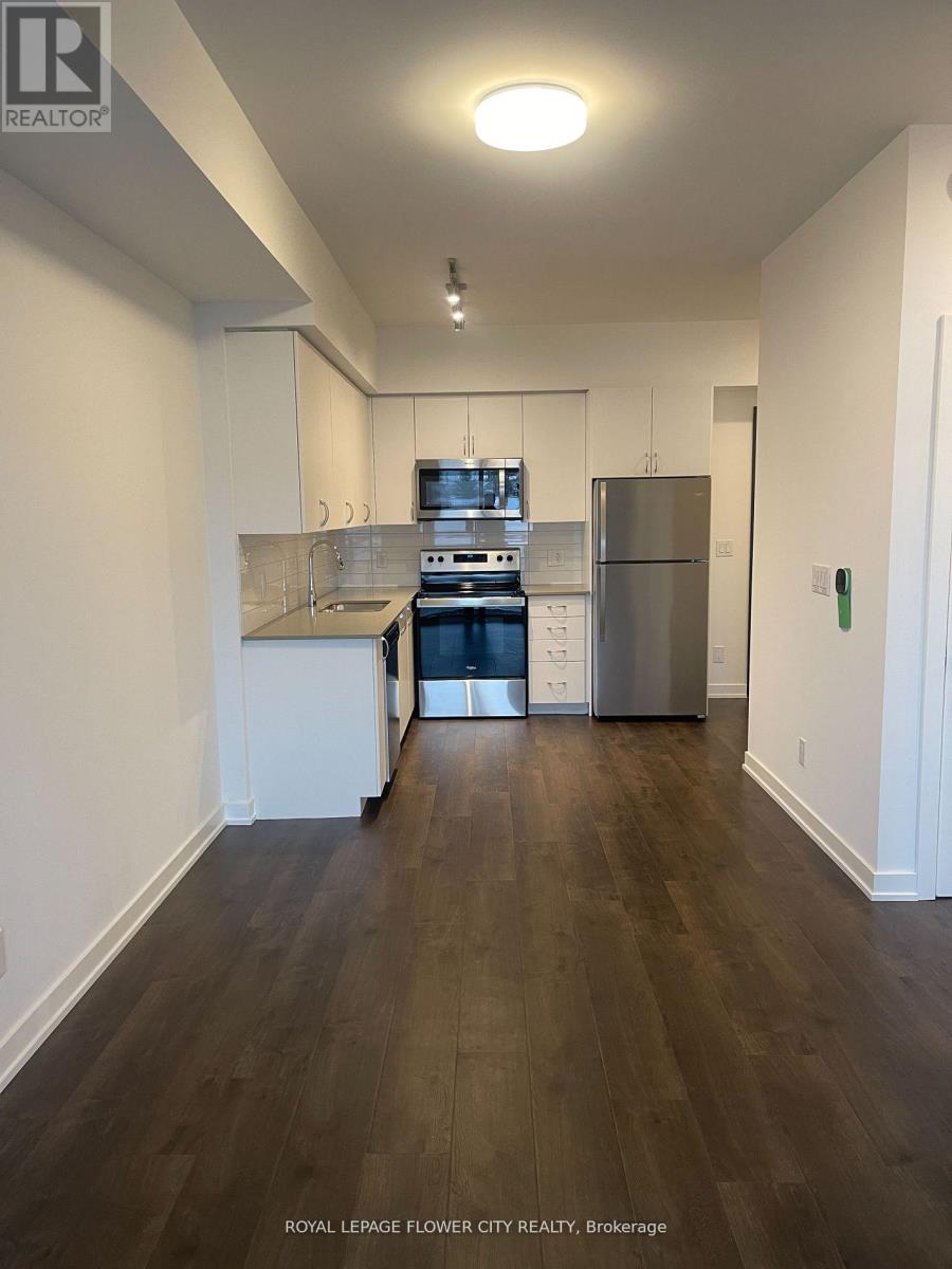 A kitchen with white cabinets and stainless steel appliances.