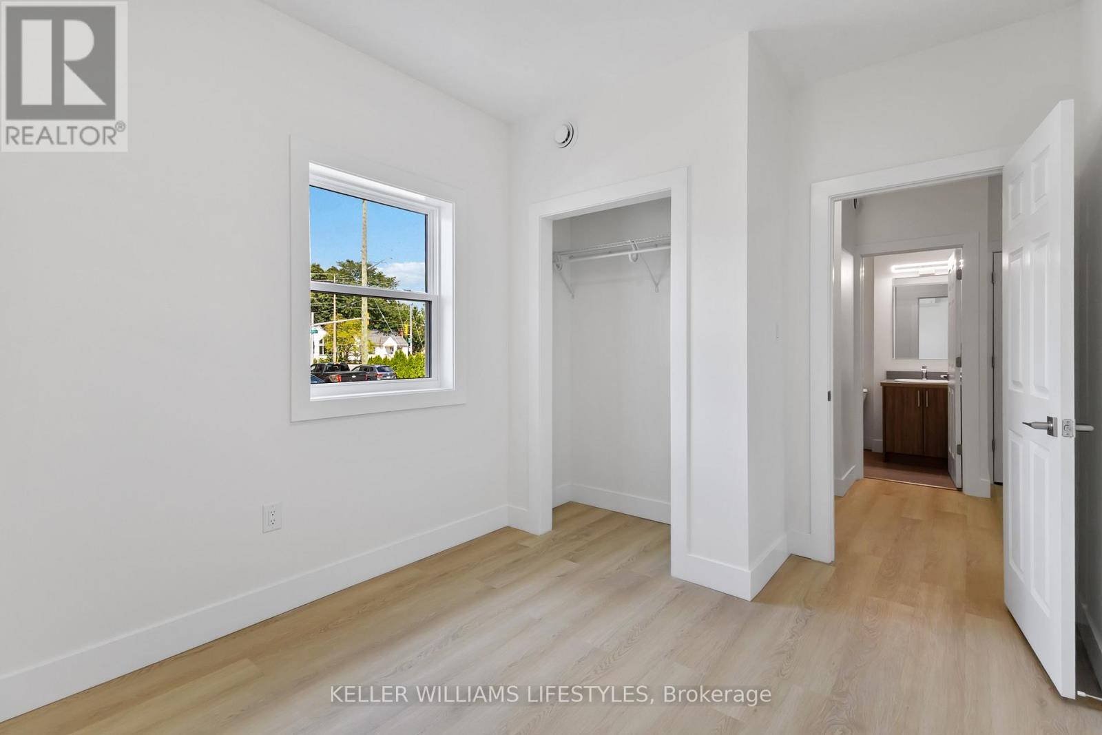 A spacious room with a view of the outdoors through a window.