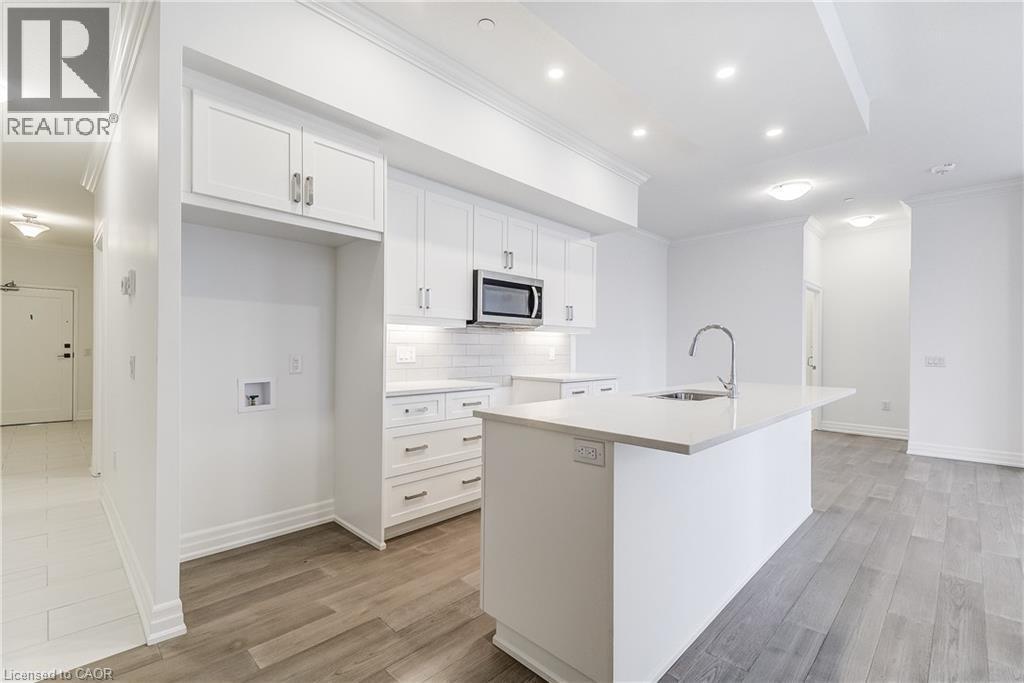 A modern kitchen with white cabinets and a central island.
