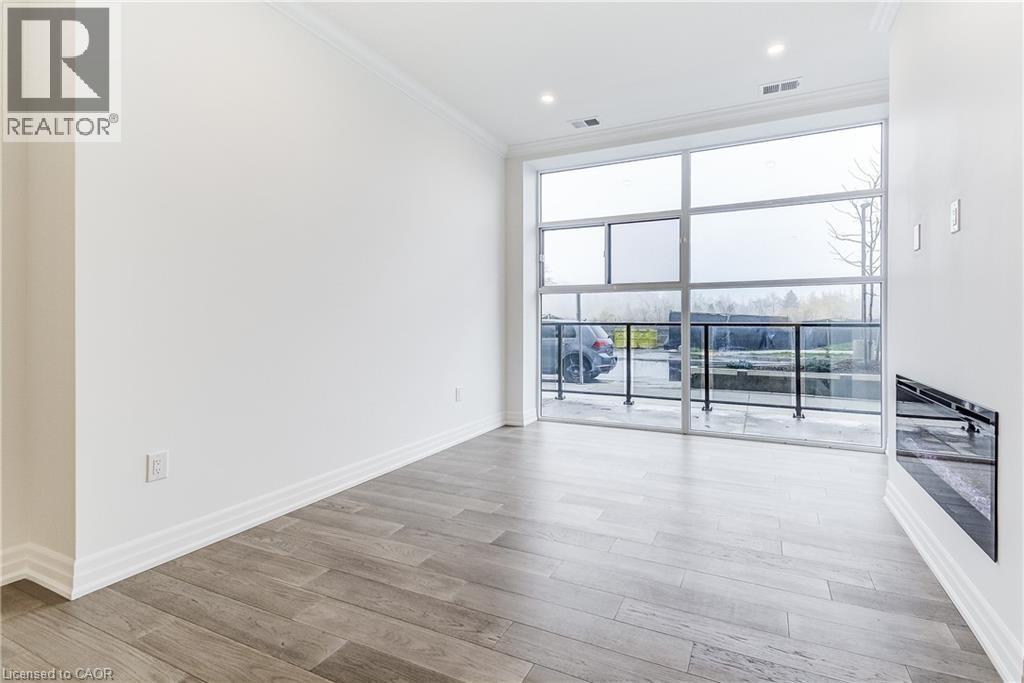 A spacious room with a large window and sliding glass doors.