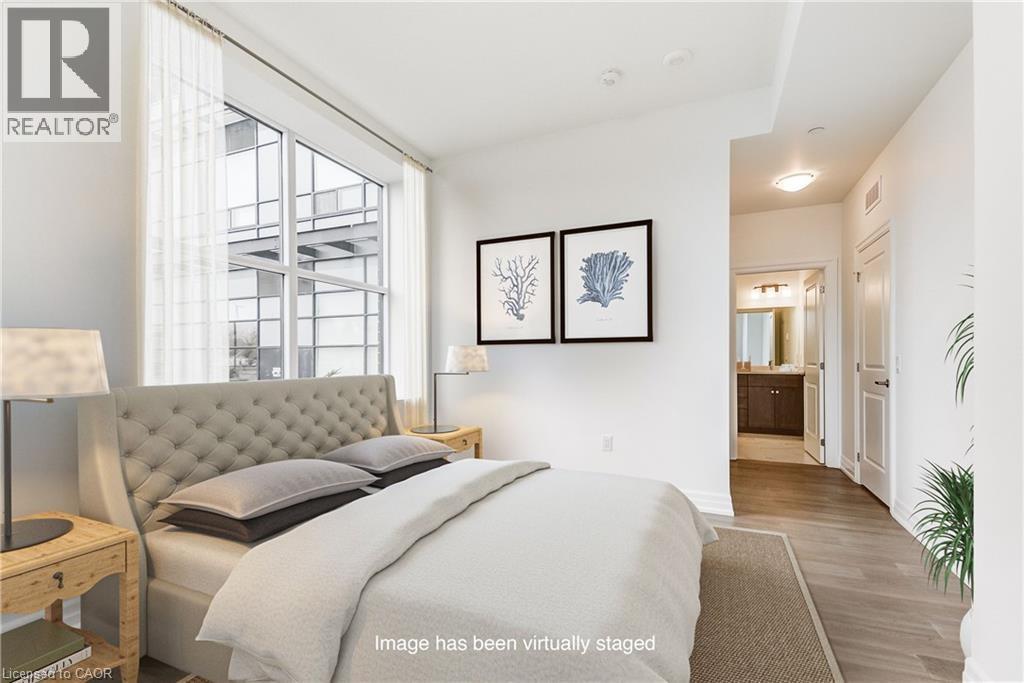 A bedroom with a bed, nightstand, and two framed pictures on the wall.