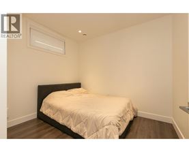 A bedroom with a bed and a window.