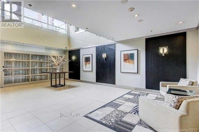 A living room with a couch, a table, and a painting on the wall.