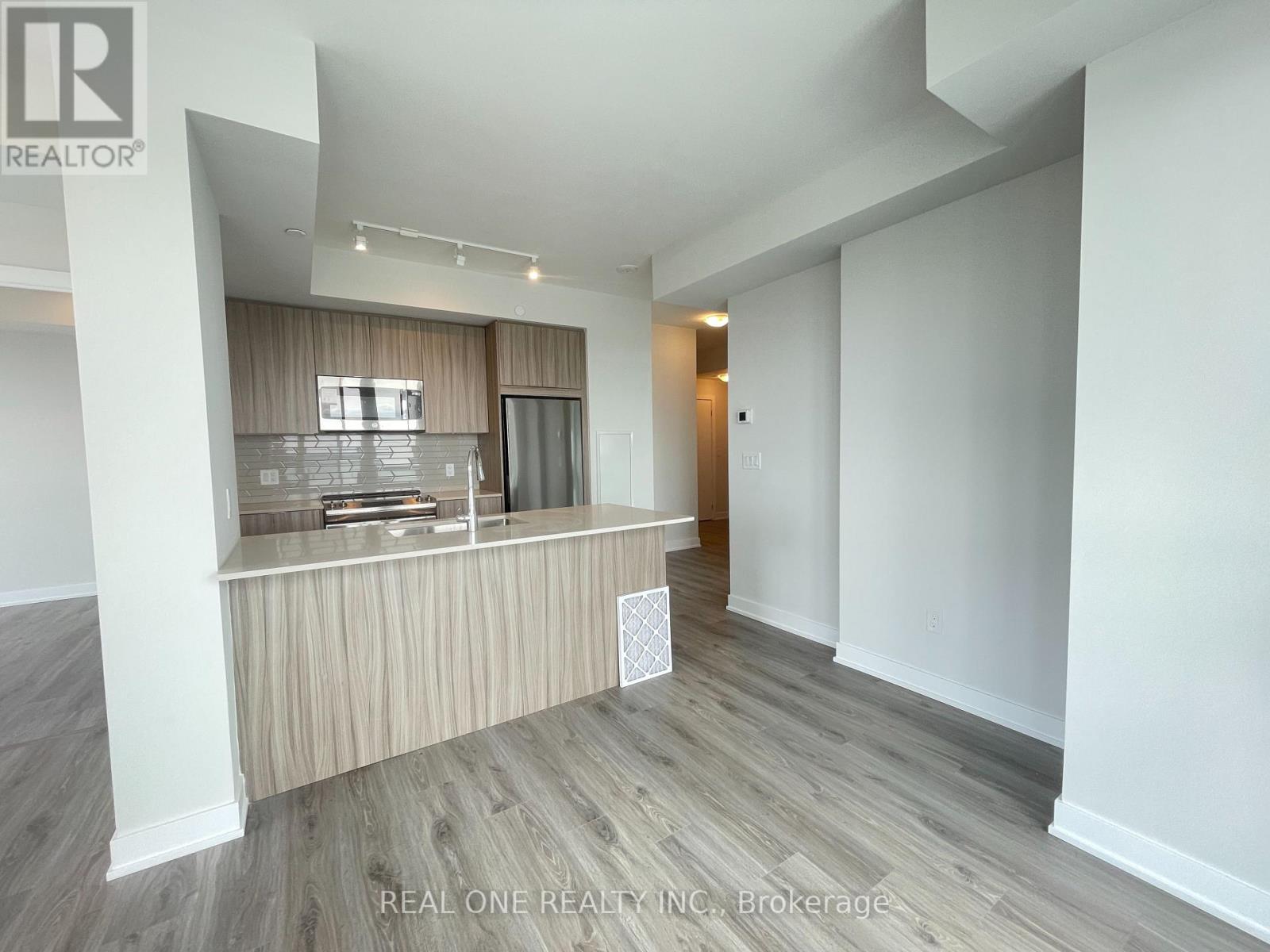 A spacious room with a reception desk and a door leading to another room.