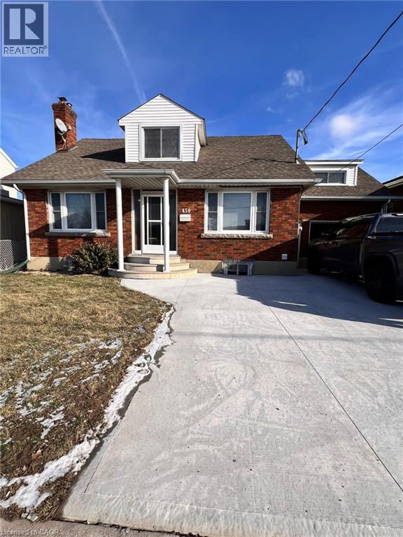 A house with a white garage door and a brick chimney.
