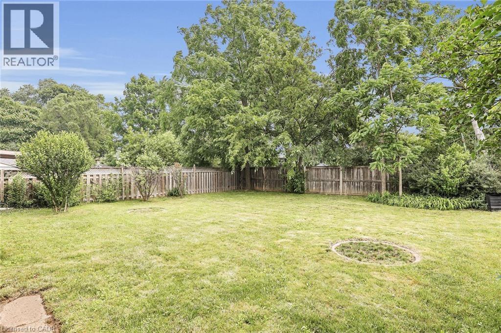 A backyard with a well-maintained lawn and a fence.
