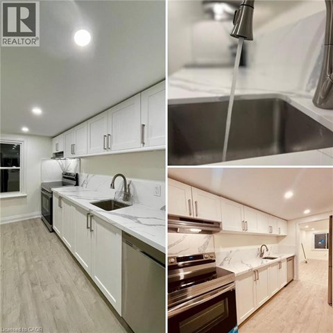 A modern kitchen with white cabinets and a marble countertop.