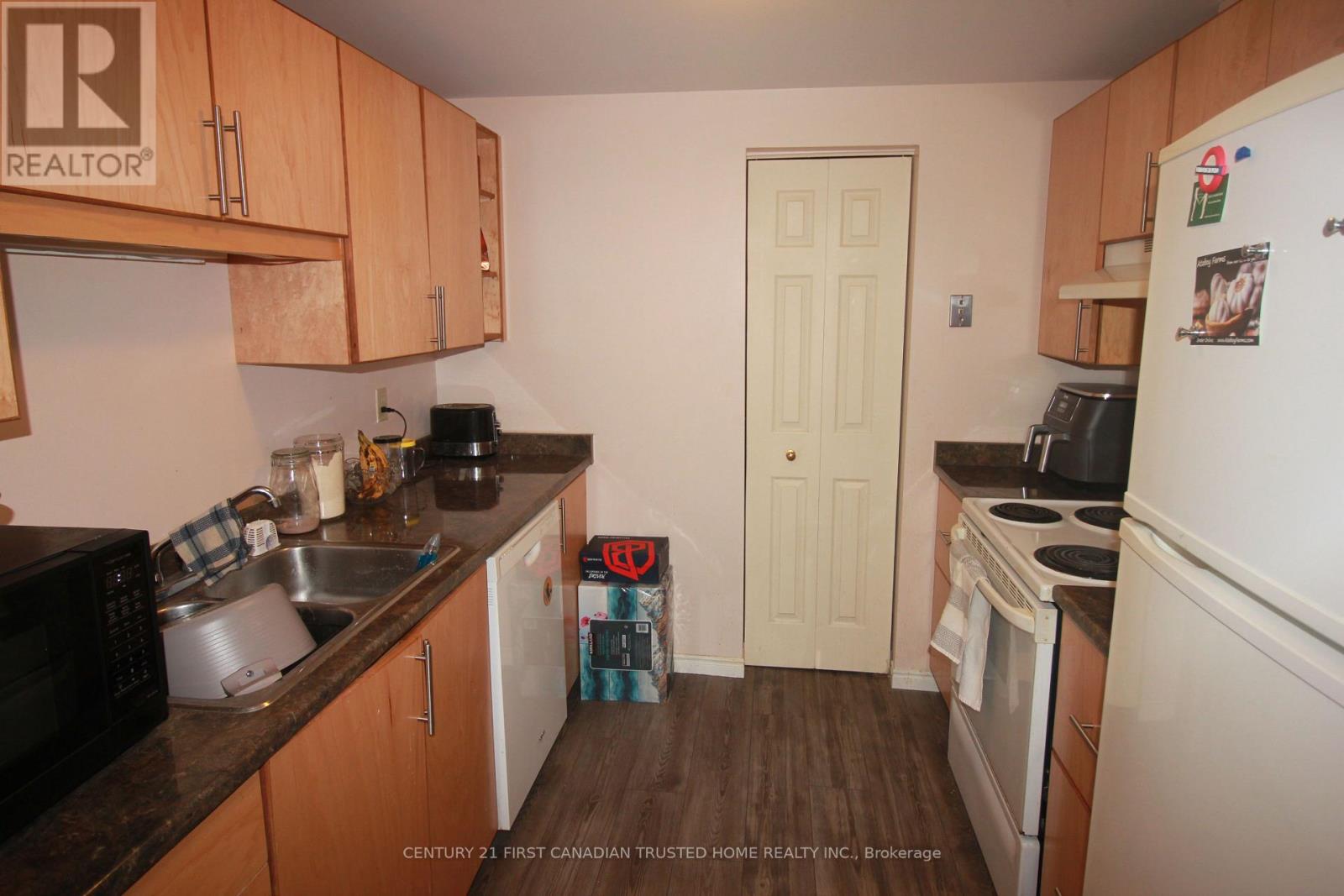 A kitchen with wooden cabinets and a white refrigerator.