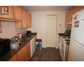 A kitchen with wooden cabinets and a white refrigerator.