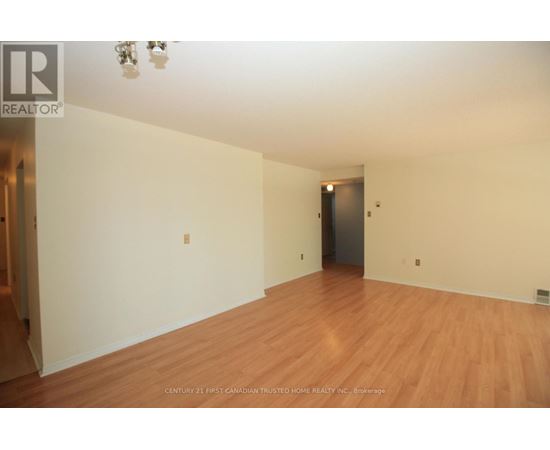 A bedroom with a bed, chair, and fan.