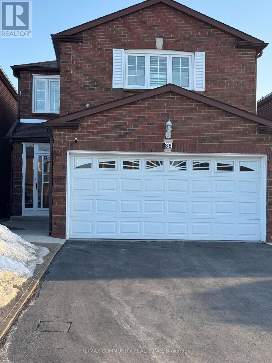 A house with a white garage door is for sale.