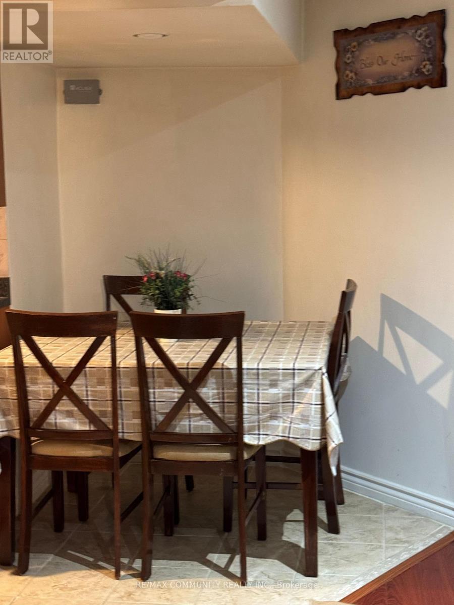 A dining room with a table and chairs.