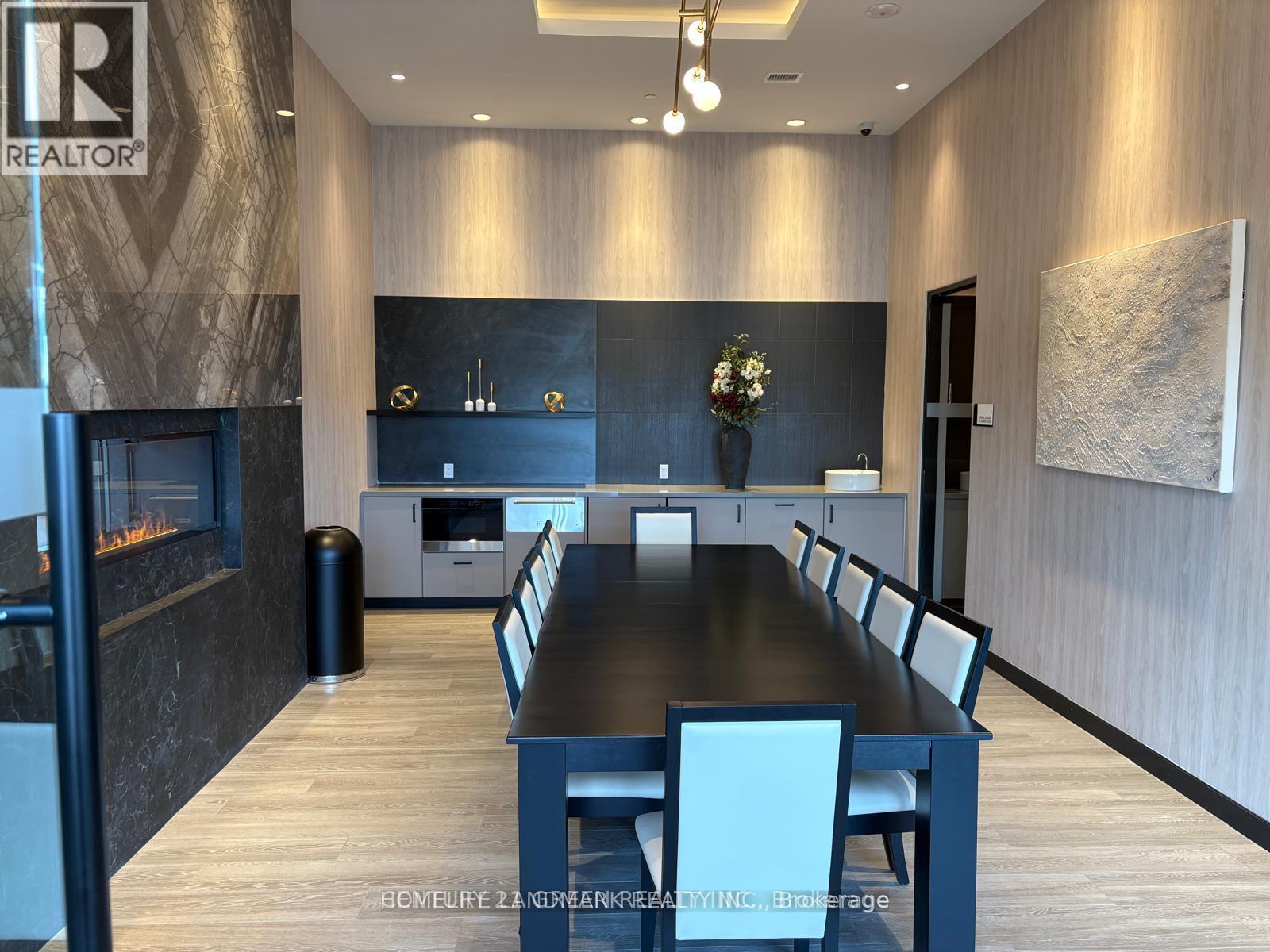 A modern dining room with a long table and chairs.