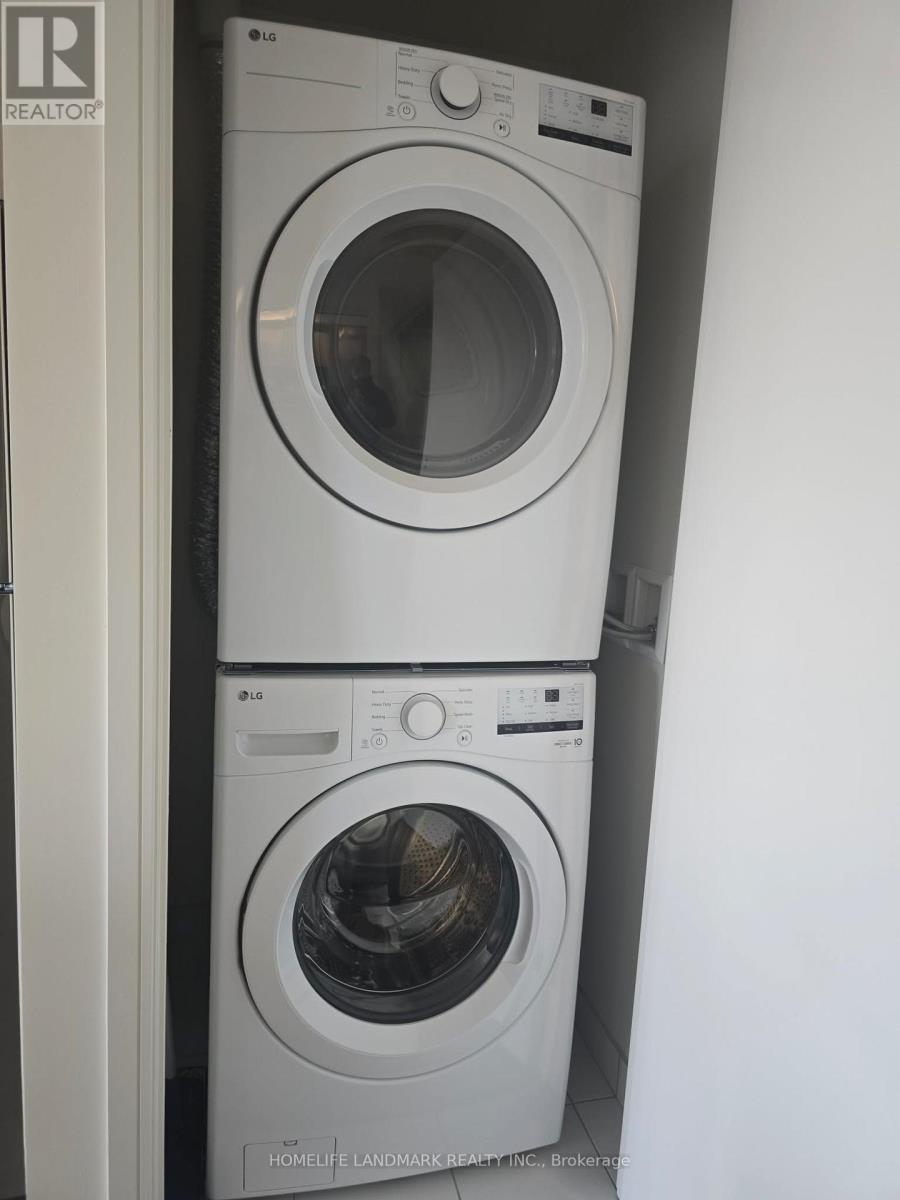 Two white front loading washing machines in a small space.